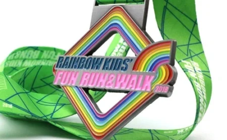 Custom kids fun run medal with rainbow enamel design and green ribbon